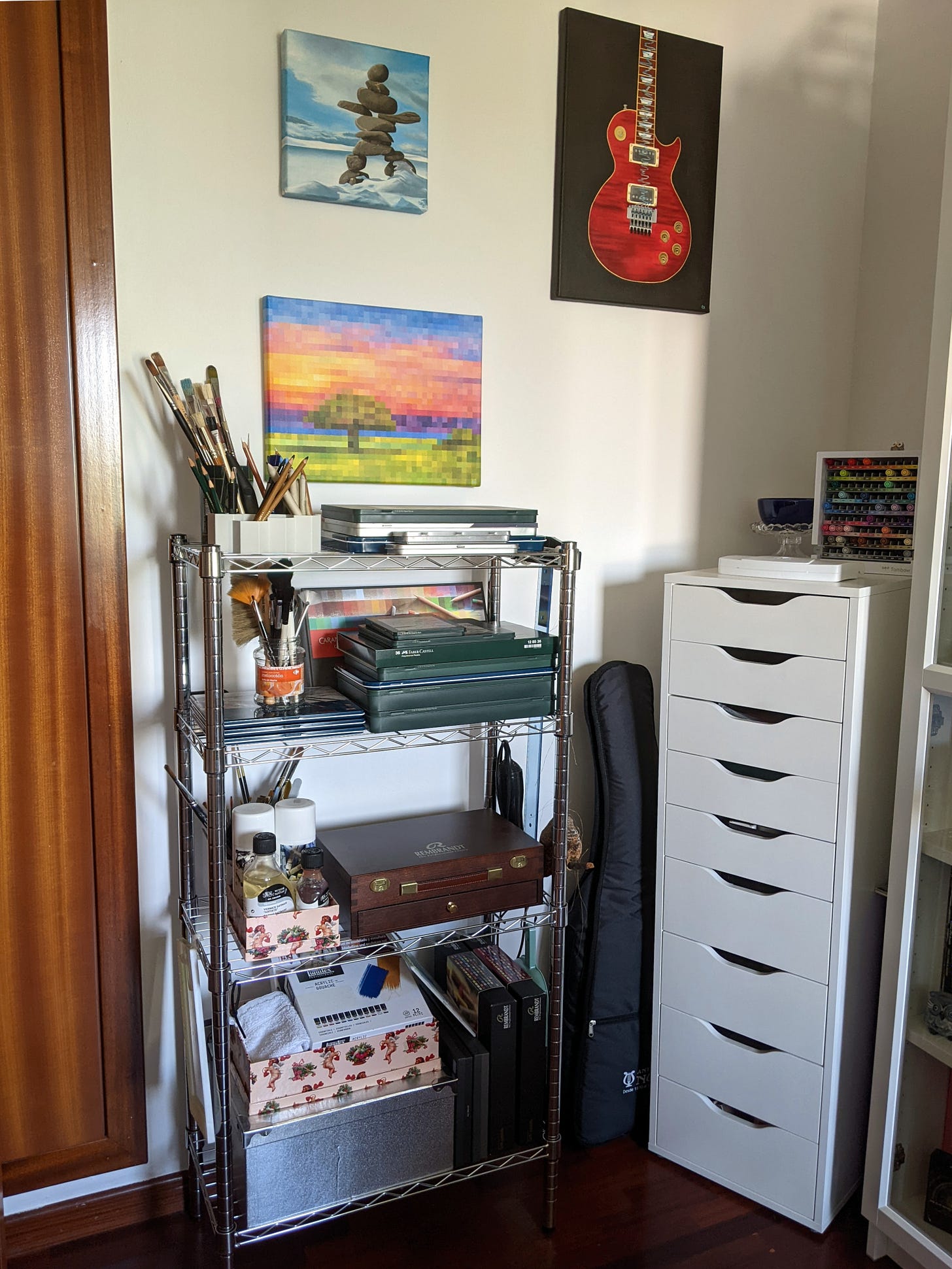 Corner of a room with artworks and art supplies.