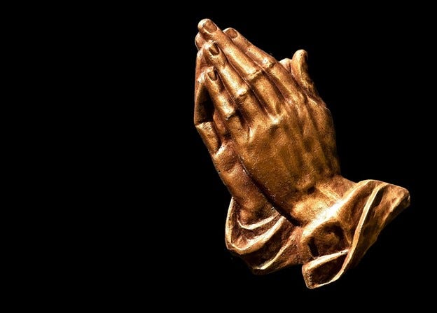 Hands I n prayer  gold