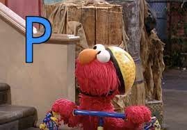 elmo from sesame street (red muppet puppet) on a tricycle on an urban street with the letter "P" visible on screen, which elmo's staring at