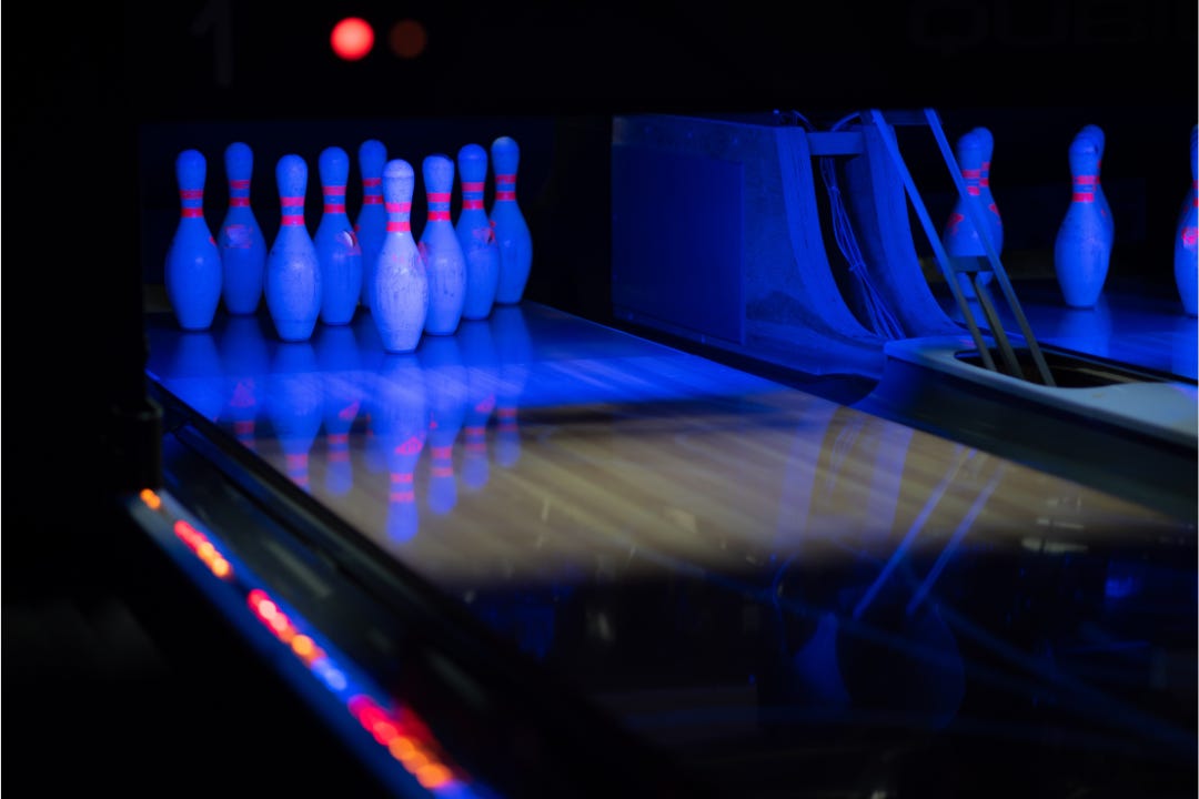 bowling alley lit up with glowing black lights