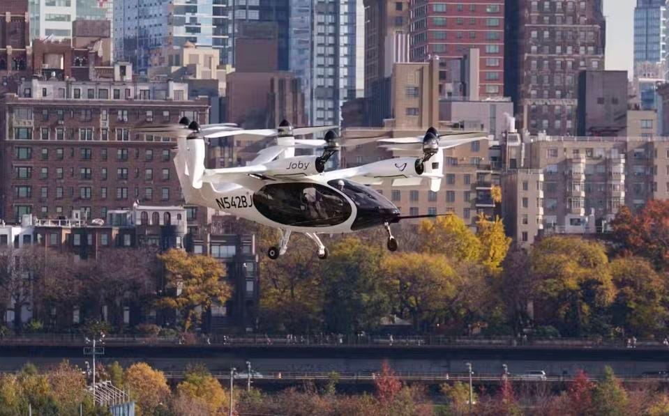 Joby’s electric air taxi in the skies above New York City, piloted by James “Buddy” Denham.