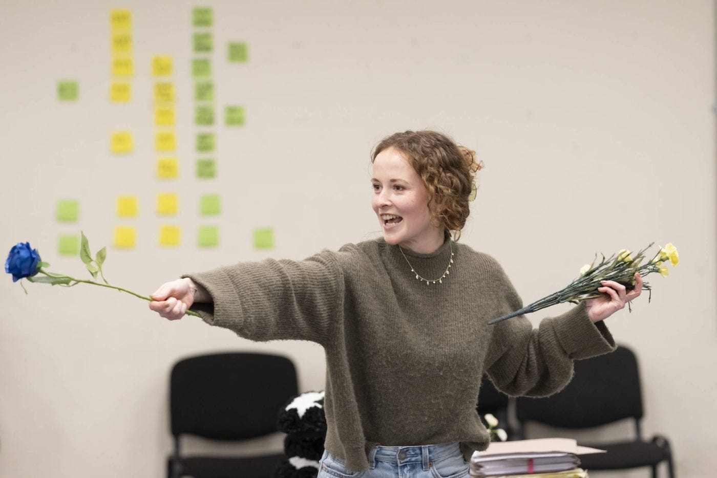 A photo showing Shannon Tarbet in rehearsals for Three Sisters, waving a rose