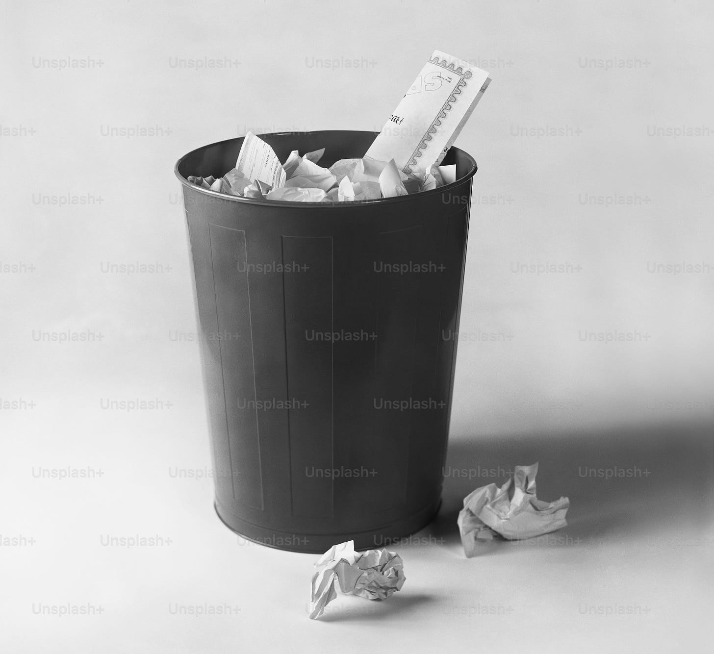 a black and white photo of a trash can