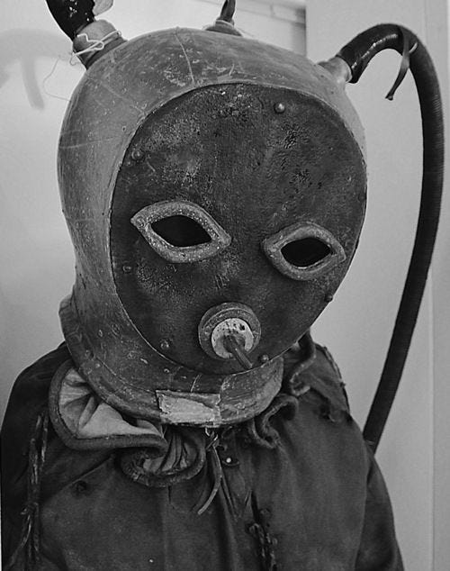 An antique leather diving costume from the 18th century with and black, other worldy eyes
