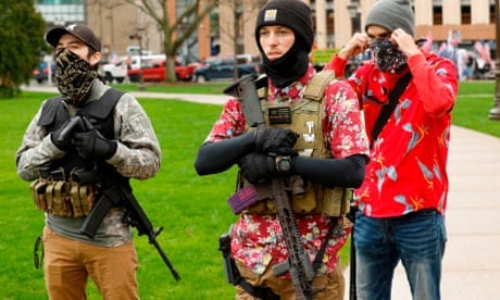 Armed protesters provide security for a protest demanding reopening in Lansing, Michigan, on 30 April. Members of the ‘boogaloo’ movement wear Hawaiian shirts paired with body armor and a military-style rifle. 