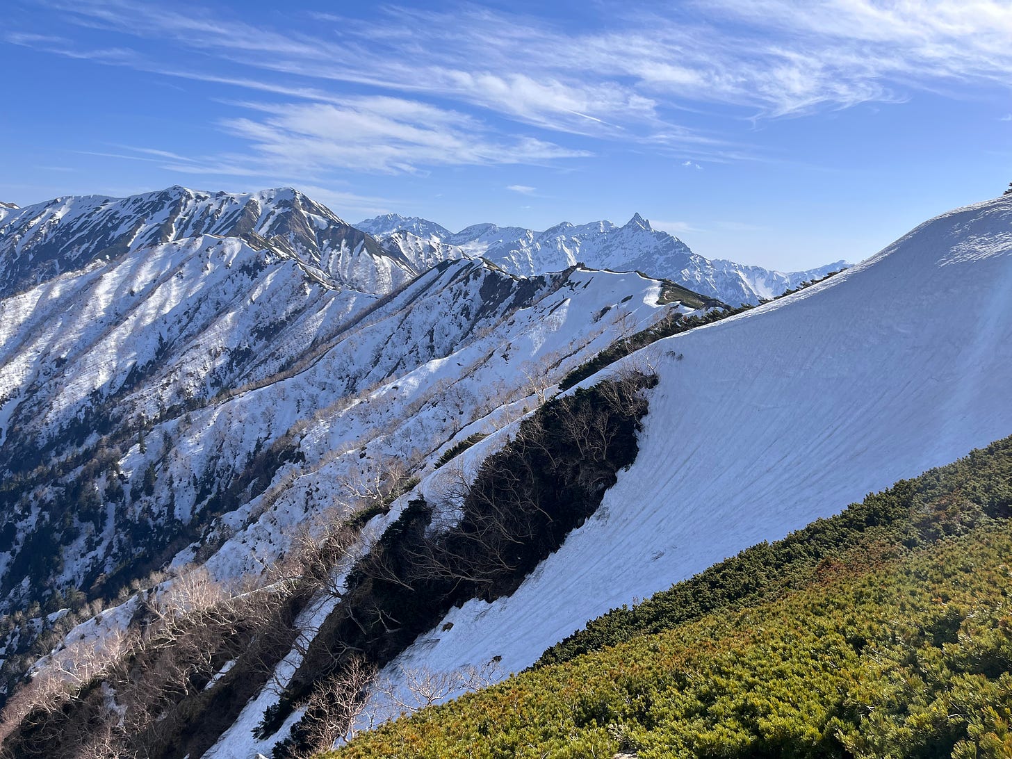 snow covered mountains with a blue sky