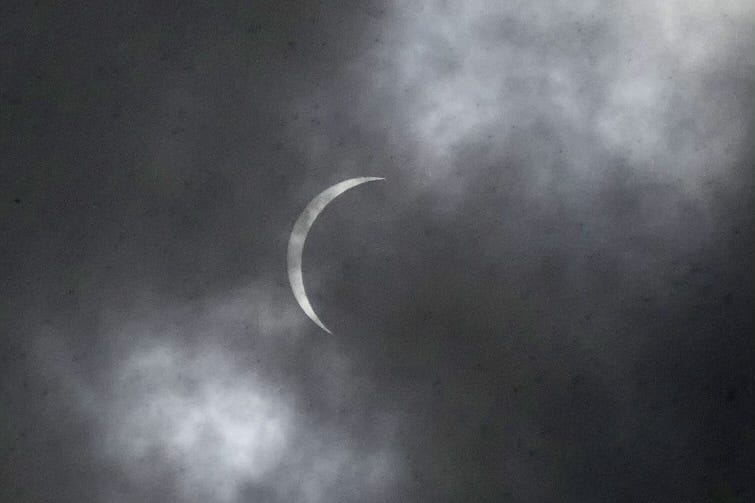 Partial eclipse behind cloud cover