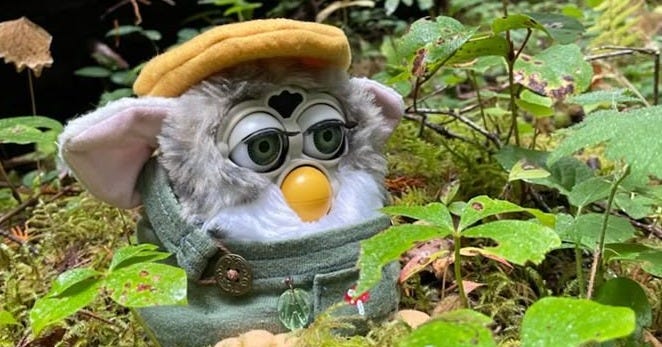 This may contain: a small toy in the middle of a forest with trees and leaves around it, wearing a hat