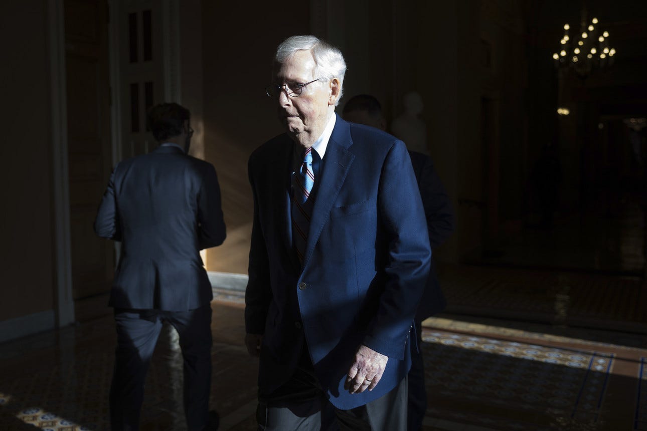 Mitch McConnell walks down the hall of the U.S. Capitol.