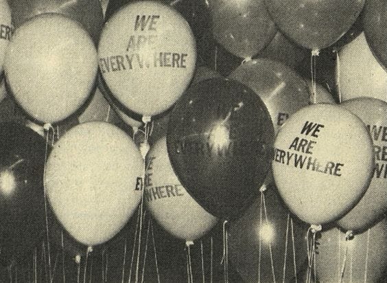 This may contain: black and white photograph of balloons with we are everywhere written on them