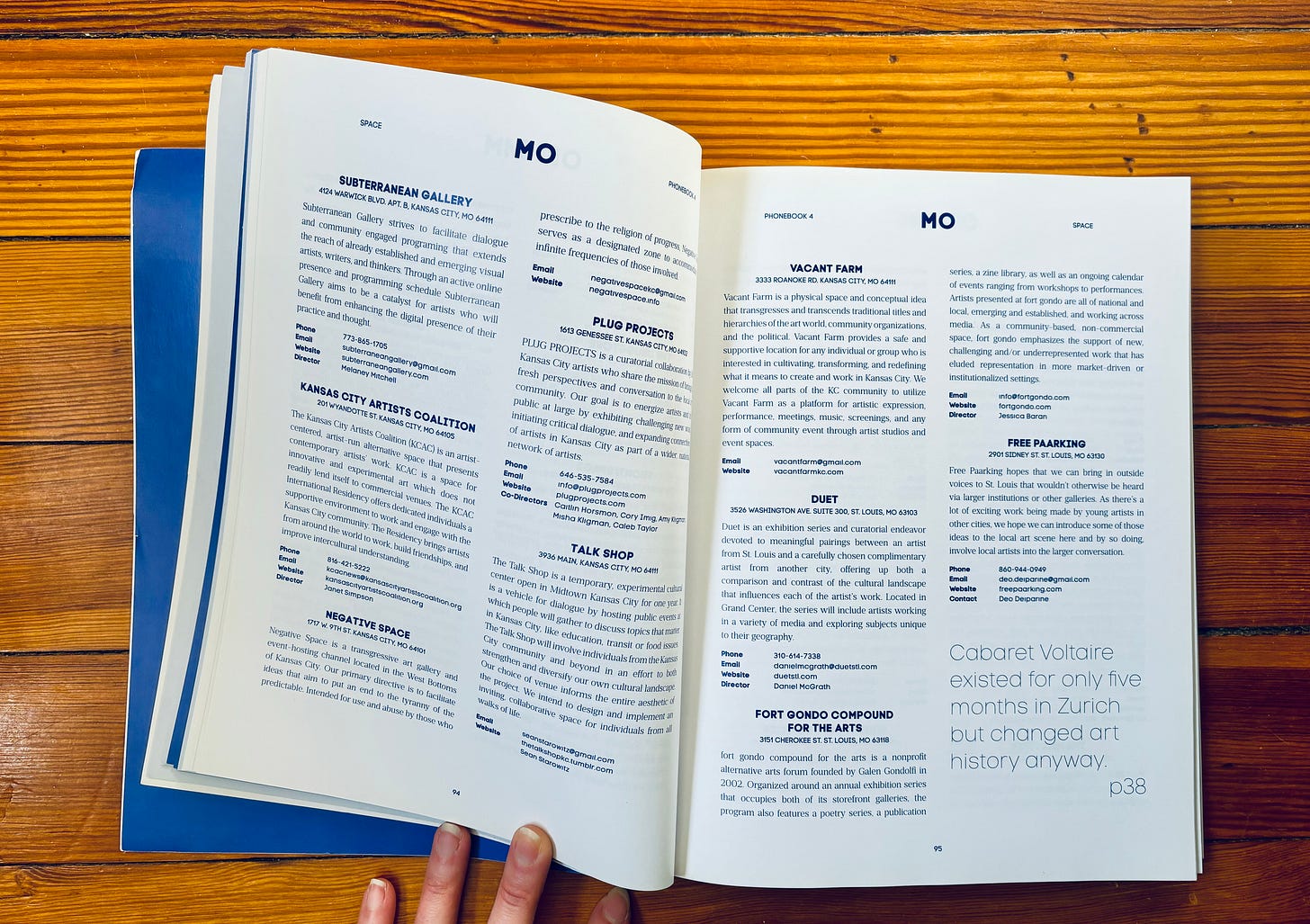 an open book displaying several listings of art spaces and initiatives based in Missouri