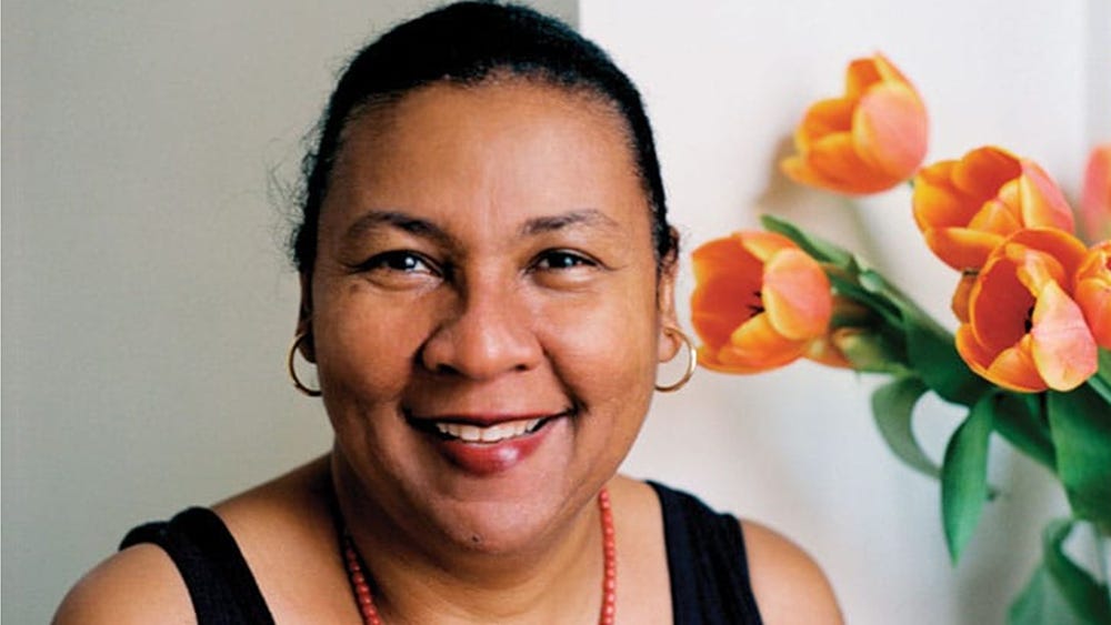 A beautiful image of a smiling bell hooks, with tulips