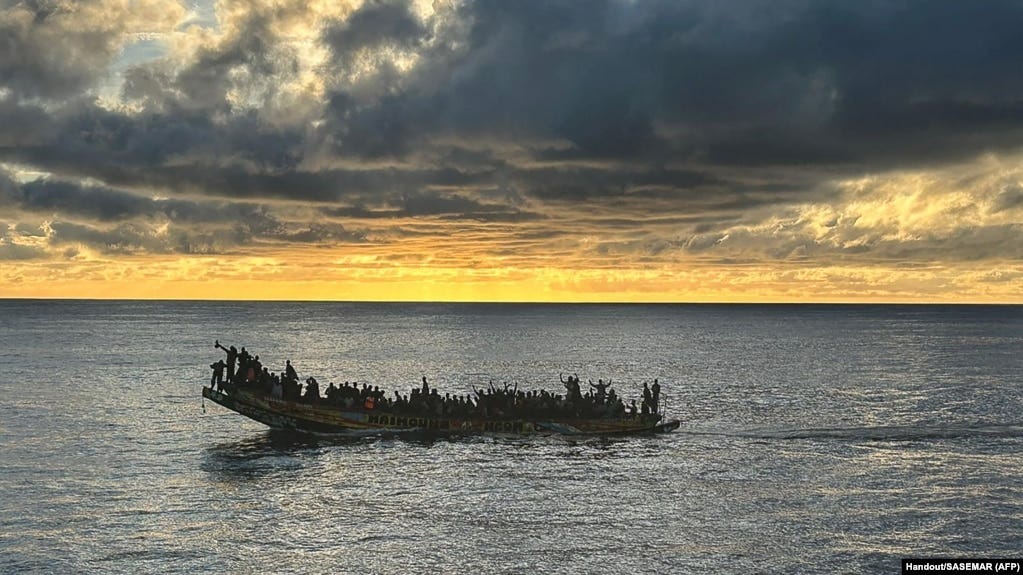 This handout photograph released on Oct. 30, 2023 by the Spanish Maritime Rescue and Safety Society SASEMAR shows migrants aboard a "cayuco" wooden boat, off the coast of the Canary island of Tenerife. 