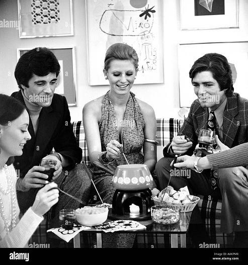 two beautiful couples in the 1970s sharing fondue