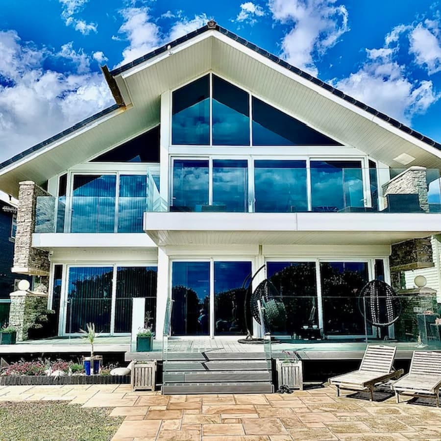 External view of the house of glass, a gorgeous modern glass home with white exterior