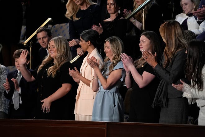 January Littlejohn wears a blue dress during President Trump's address to a joint session of Congress at the U.S. Capitol in Washington, D.C., on March 4, 2025.