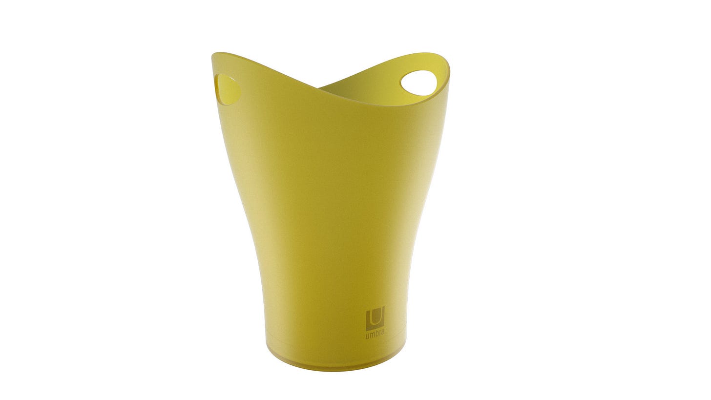 Green wastebasket with curved top and two oval holes for gripping