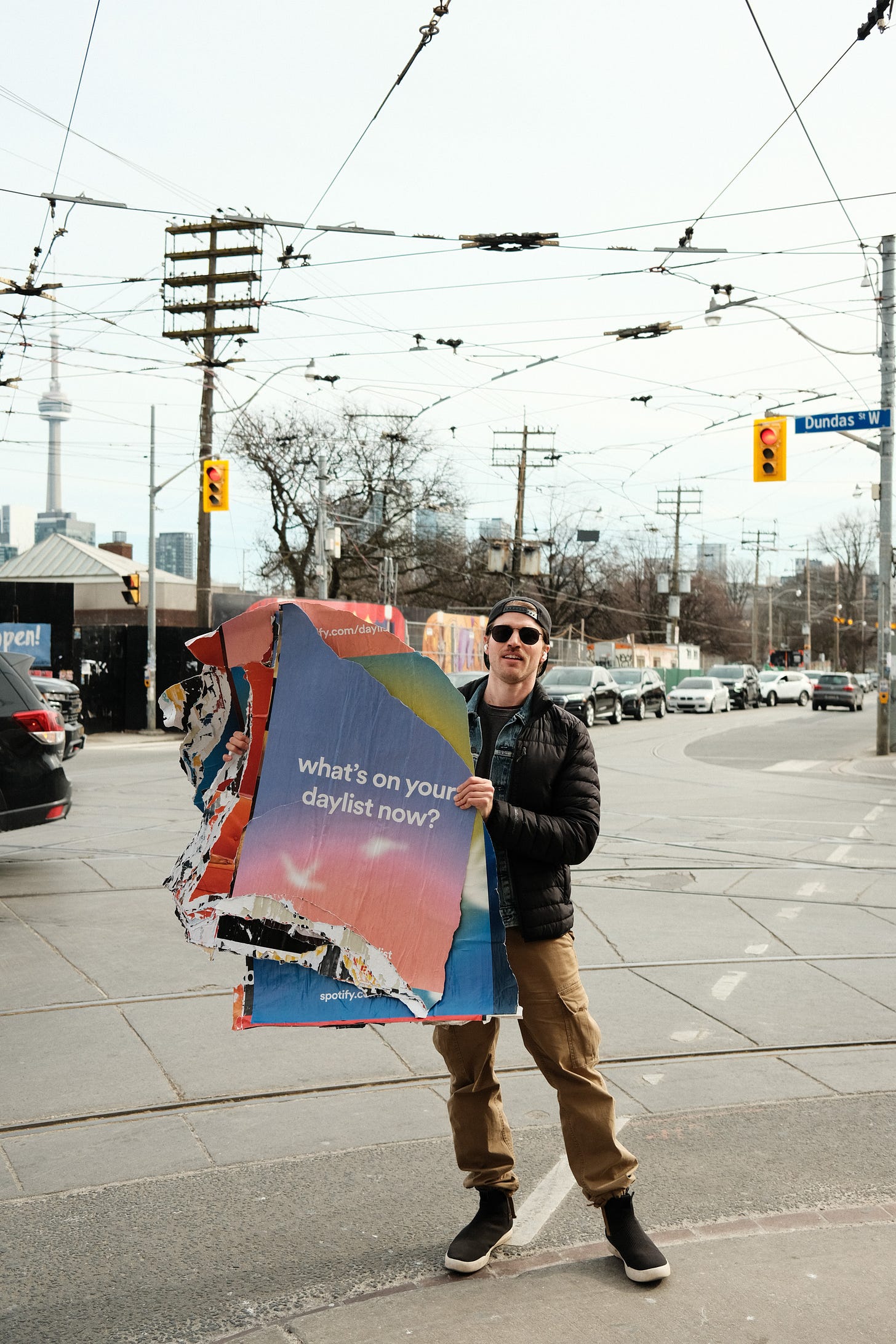 Me on a Toronto street with an acquired piece of Spotify marketing material