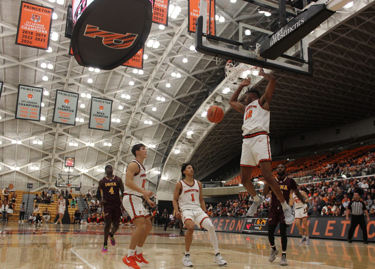 Jacob Huggins (12) dunks during Princeton’s 81-80 win over Iona on Nov. 4, 2024. (Photo by Adam Zielonka)