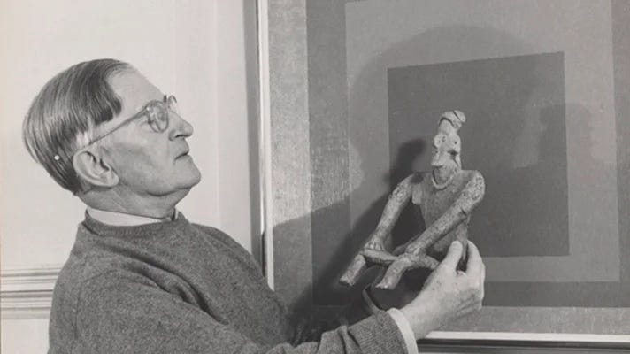 Lee Boltin, Untitled (Josef Albers Holding West Mexican Figure in front of Homage to the Square: Auriferous), 1958. © Lee Boltin. Photo courtesy of the Josef and Anni Albers Foundation.