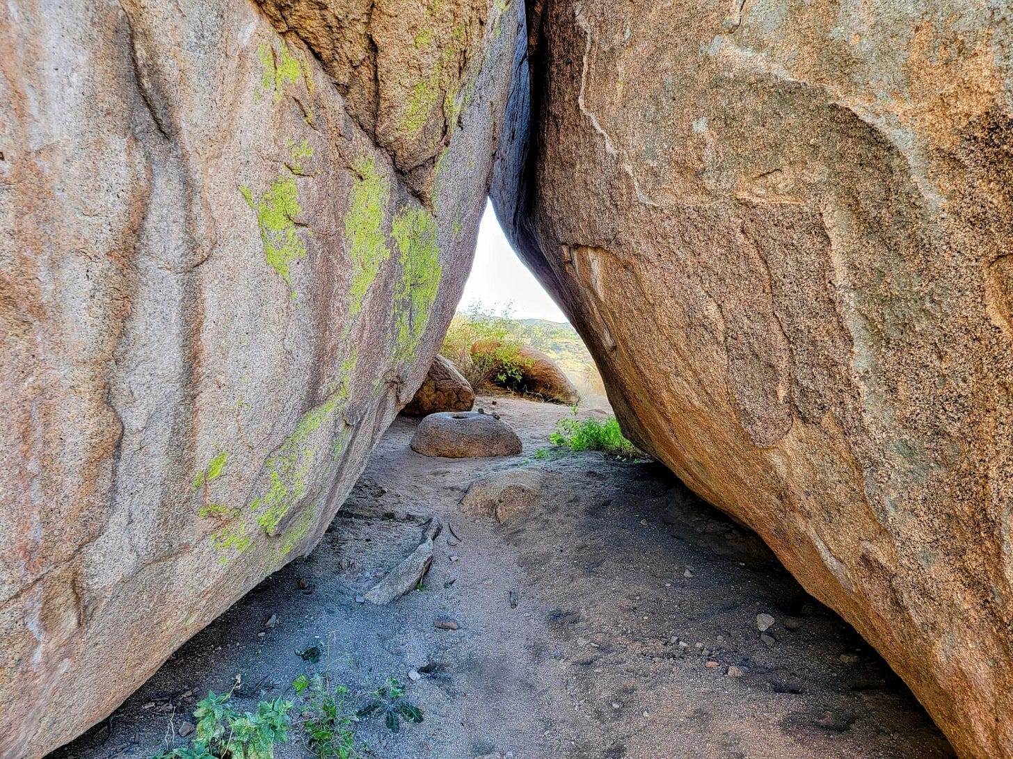 Looking Between Two Large Boulders With Neon Green Lichen looking between two large boulders with neon green lichen
