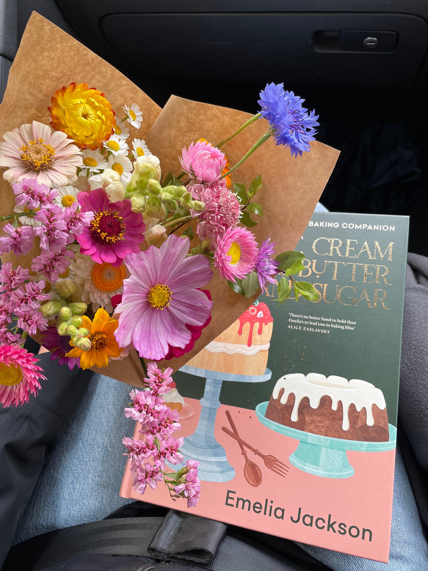 Bunch of flowers and a baking cookbook, taken in a car.