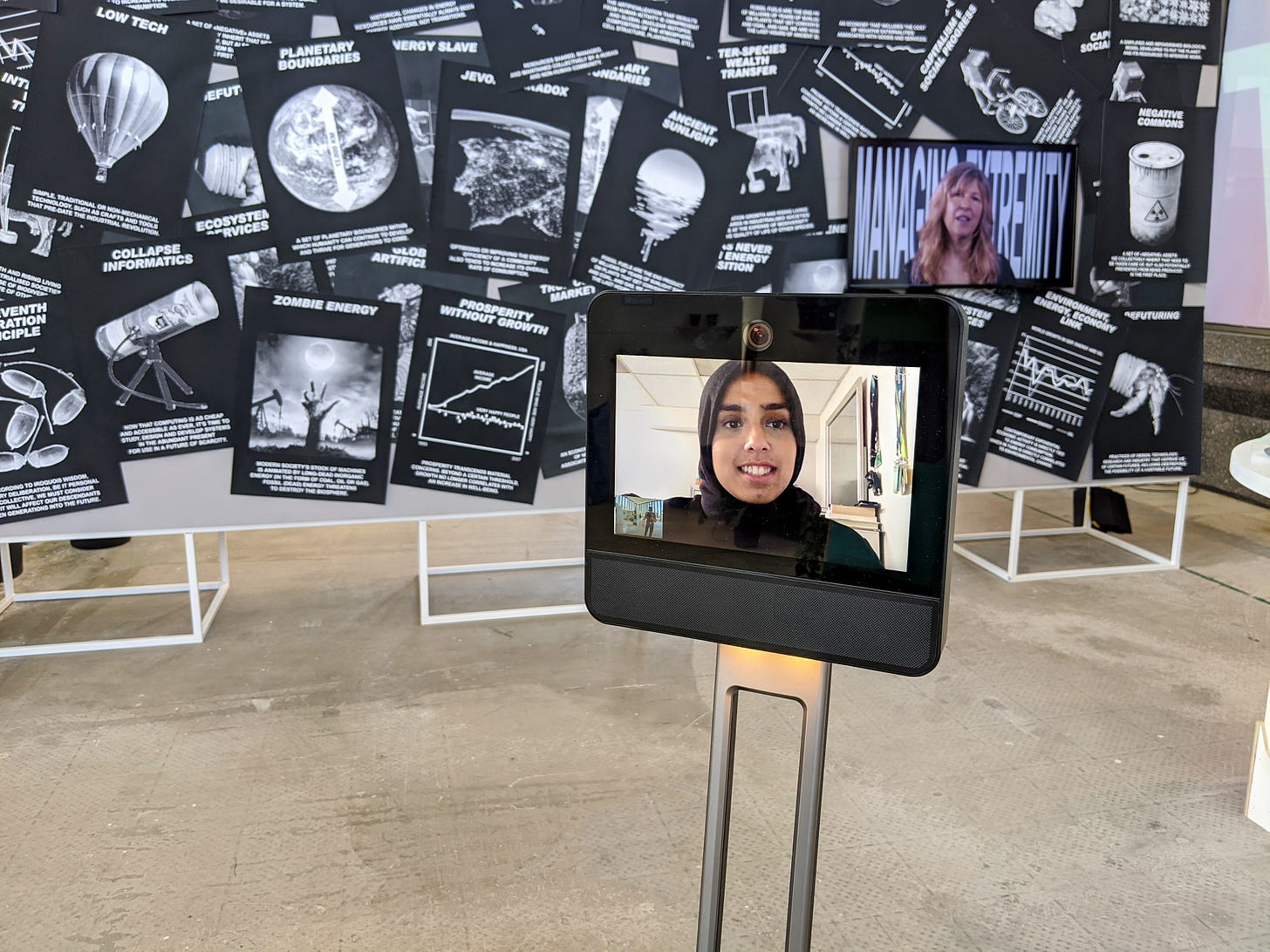 A portrait of a CoLaborator on the screen of a telepresence robot in the Future Present exhibition.