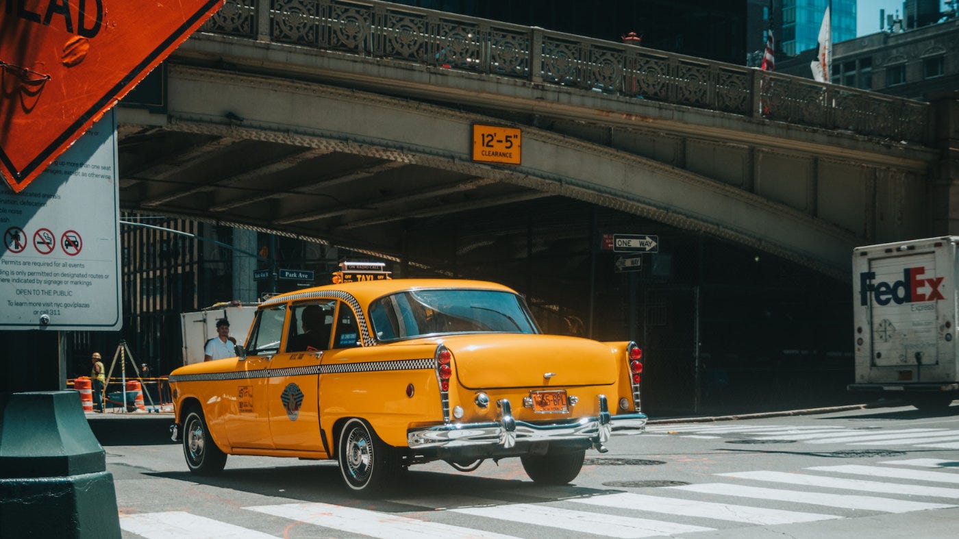 taxi going under a bridge