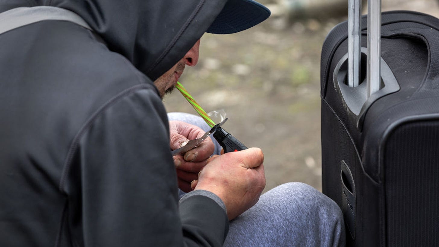 SEATTLE, WASHINGTON - MARCH 12: A homeless man, 24, smokes fentanyl on March 12, 2022 in Seattle, Washington. Widespread drug addiction is endemic in Seattle's large homeless community, which the city is currently trying to move out from shared public spaces. According to a recent report commissioned by Seattle Councilmember Andrew Lewis, the COVID-19 pandemic put undue pressure on the city's shelter system and delayed funds for new housing, leading to an increase in homelessness. (Photo by John Moore/Getty Images)