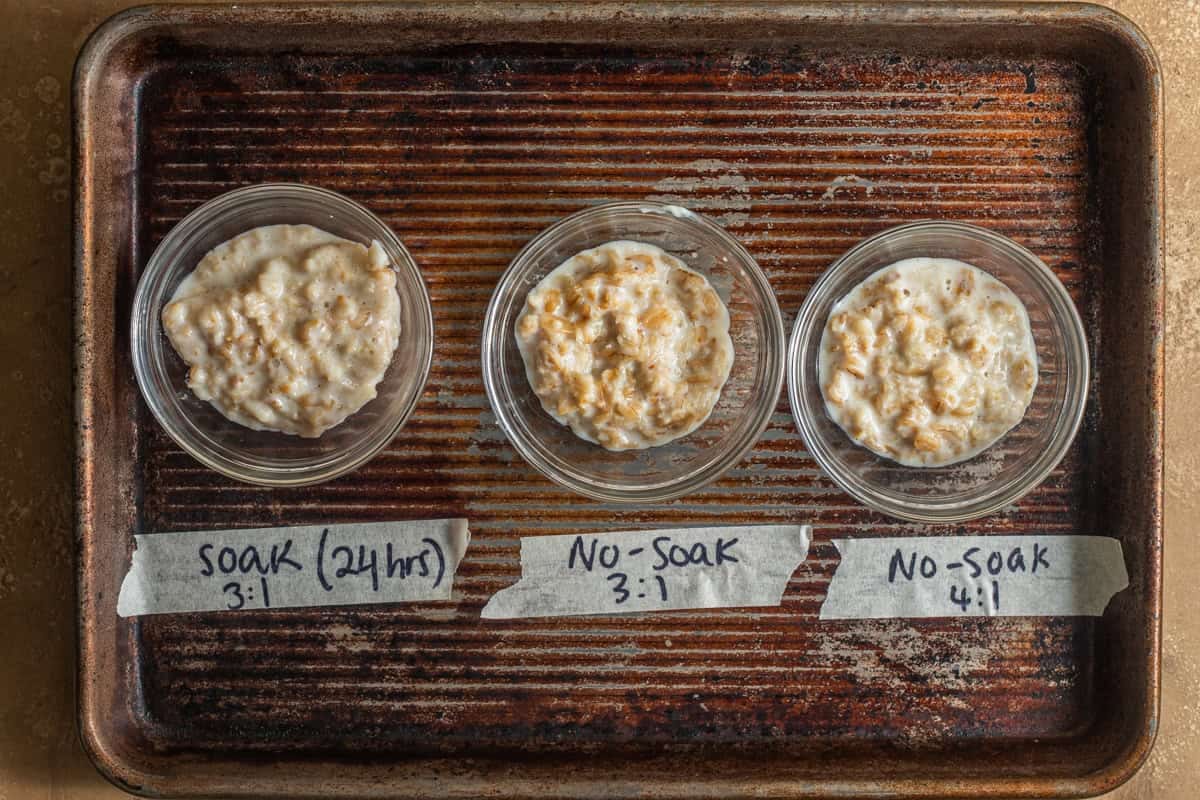 A baking sheet with 3 different variations of cooked oatmeal, a soaked version and 2 unsoaked versions.