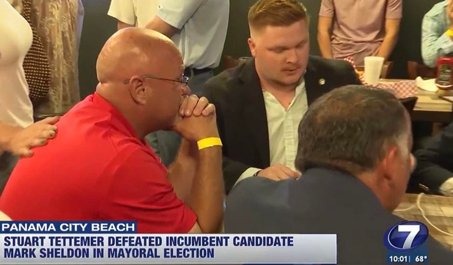 May be an image of 5 people, television and text that says 'PANAMA CITY BEACH STUART TETTEMER DEFEATED INCUMBENT CANDIDATE MARK SHELDON IN MAYORAL ELECTION 7 10:01| 10:01|68° 68°'