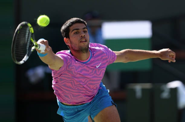 Carlos Alcaraz of Spain plays a forehand against Alexander Zverev of Germany in their Quarterfinal match during the BNP Paribas Open at Indian Wells...