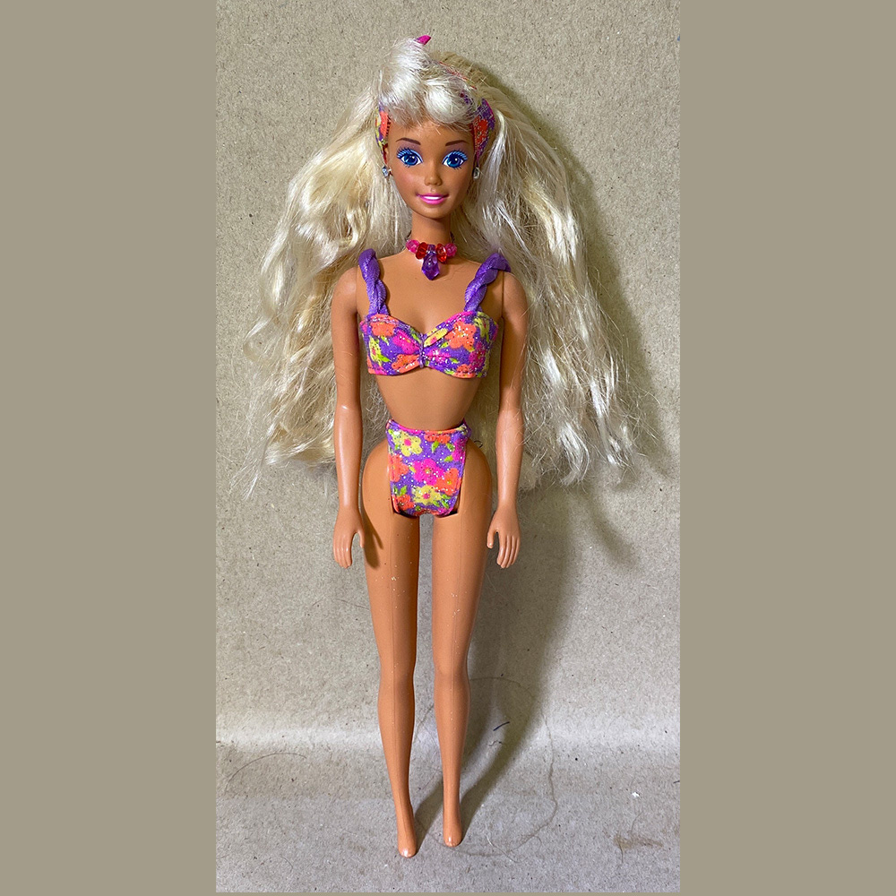 Glitter Beach Barbie with blonde hair, a purple floral bikini and jewel accessories