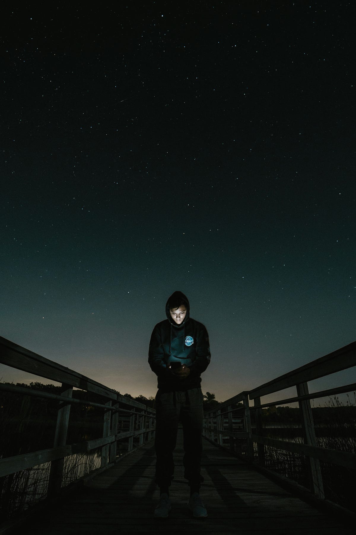 Man standing under the night sky.
