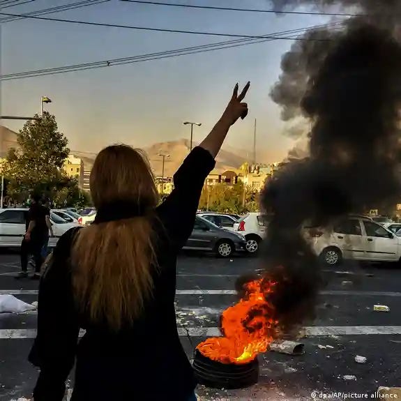 An Iranian women holds up her arm at a 2022 protest 