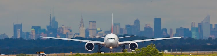 Boeing 777 with Manhattan in the background lining up on at JFK airport in New York.