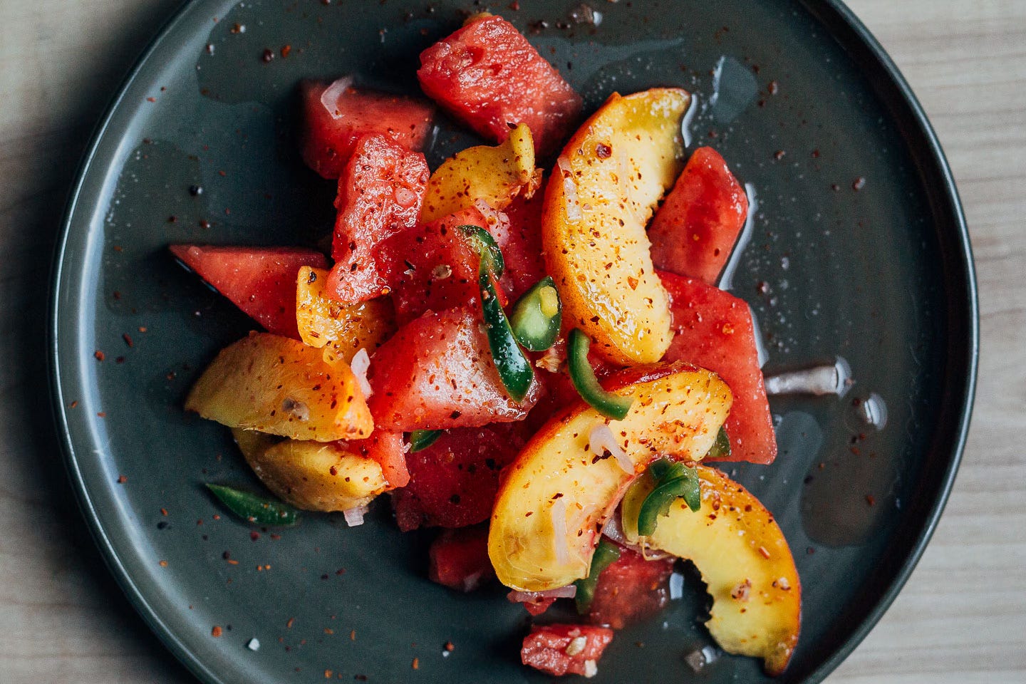 A little salad with watermelon and peaches on a plate