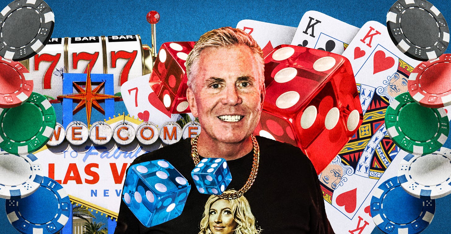 A white man with gray hair wears a black shirt and large gold chain and smiles broadly in front of a variety of Las Vegas gambling imagery: a slot machine, the "Welcome to Vegas" sign, poker chips, dice, cards.