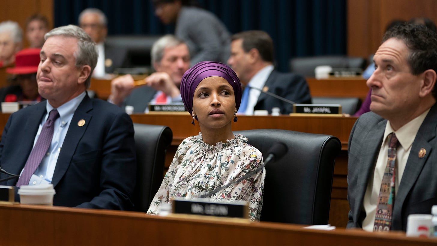 Rep. Ilhan Omar, D-Minn., sits with fellow Democrats, Rep. David Trone, D-Md., left, and Rep. Andy Levin, D-Mich., right, on the House Education and Labor Committee during a bill markup, on Capitol Hill in Washington, Wednesday, March 6, 2019. Omar stirred controversy last week saying that Israel's supporters are pushing U.S. lawmakers to take a pledge of "allegiance to a foreign country." Omar is not apologizing for that remark, and progressives are supporting her.