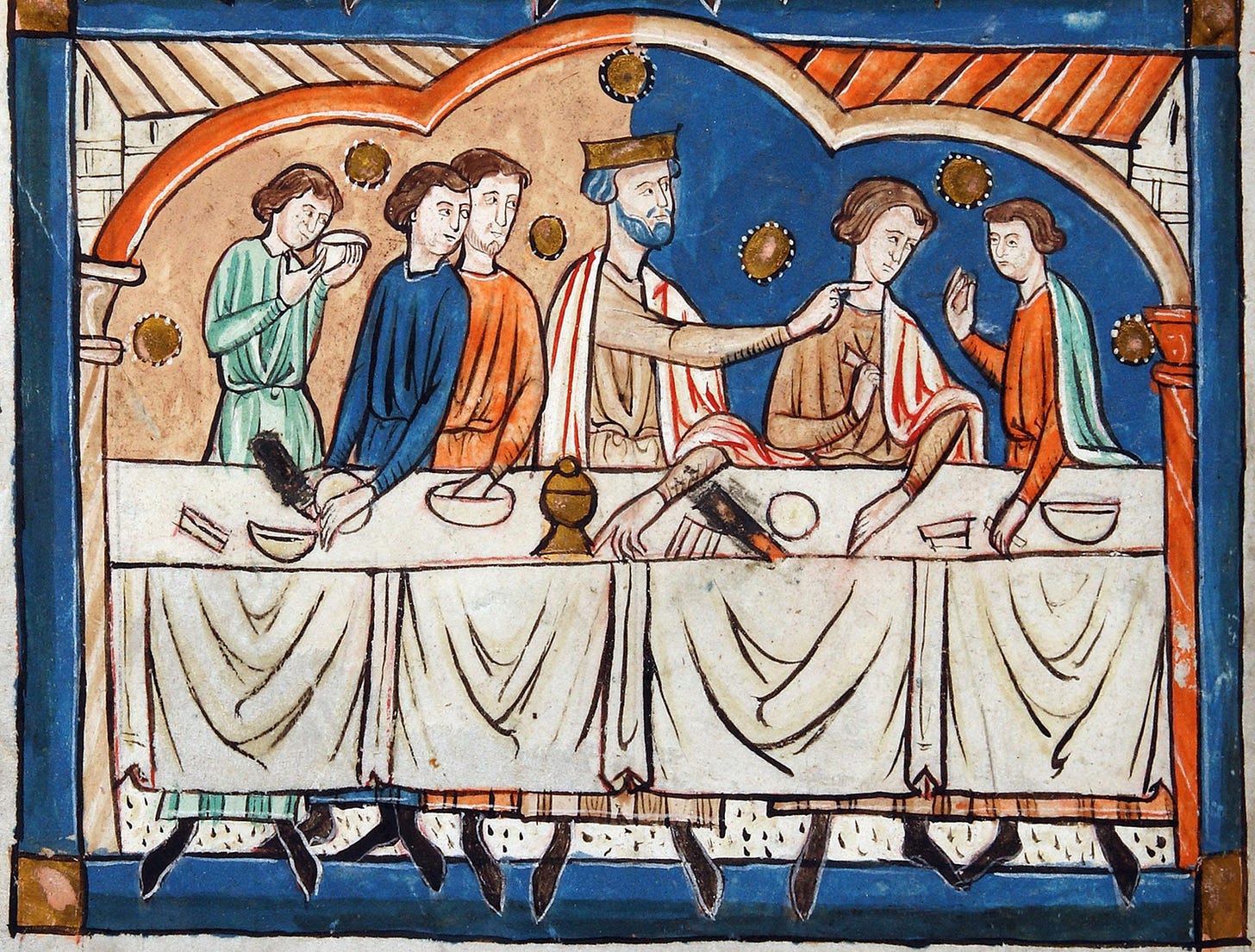 A group of men sit at a table. Edward the Confessor, clad in a crown, sits in the middle and points towards his left.