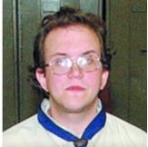 A person wearing glasses and a white shirt

Description automatically generated