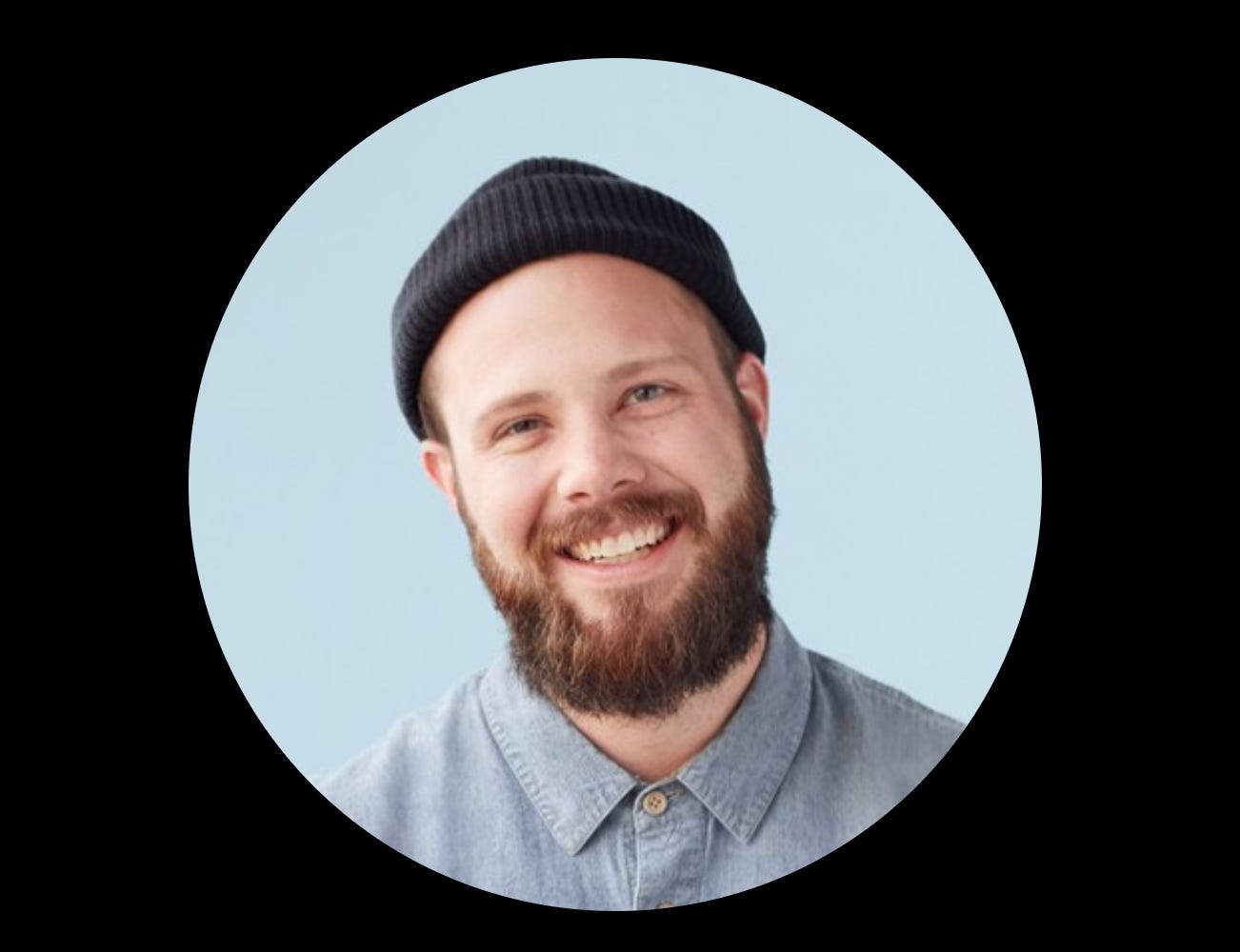 A photo of a man, Nathan Nalevanko of Kickstarter, smiling at the camera and wearing a jaunty newsboy hat. A photo of a man, Nathan Nalevanko of Kickstarter, smiling at the camera and wearing a jaunty newsboy hat.