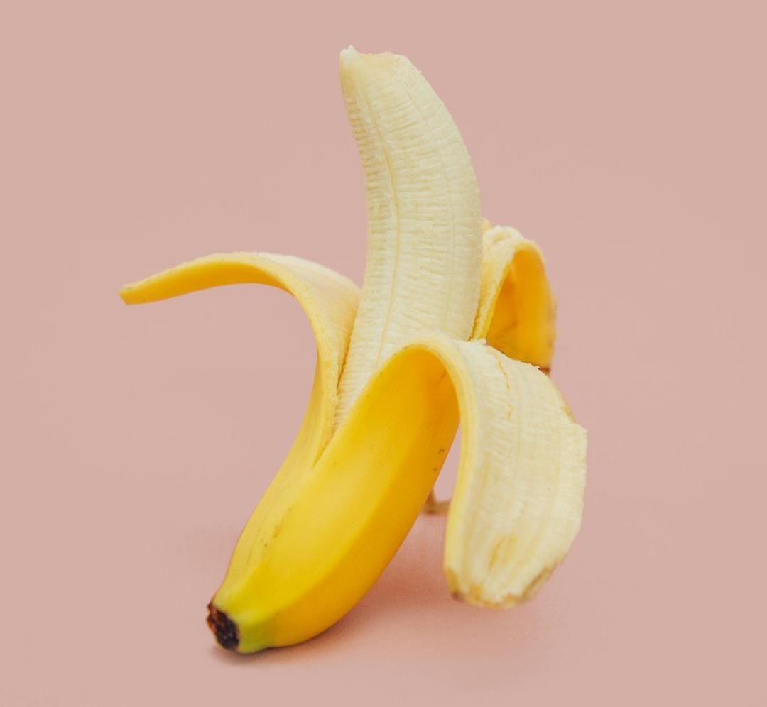 half peeled banana fruit half peeled banana fruit