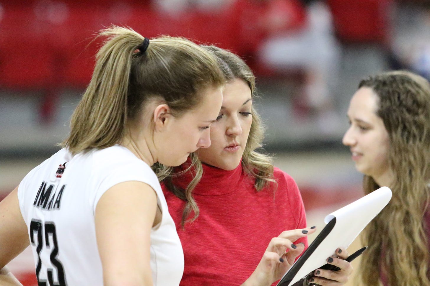 Kelly confers with a player during a time out