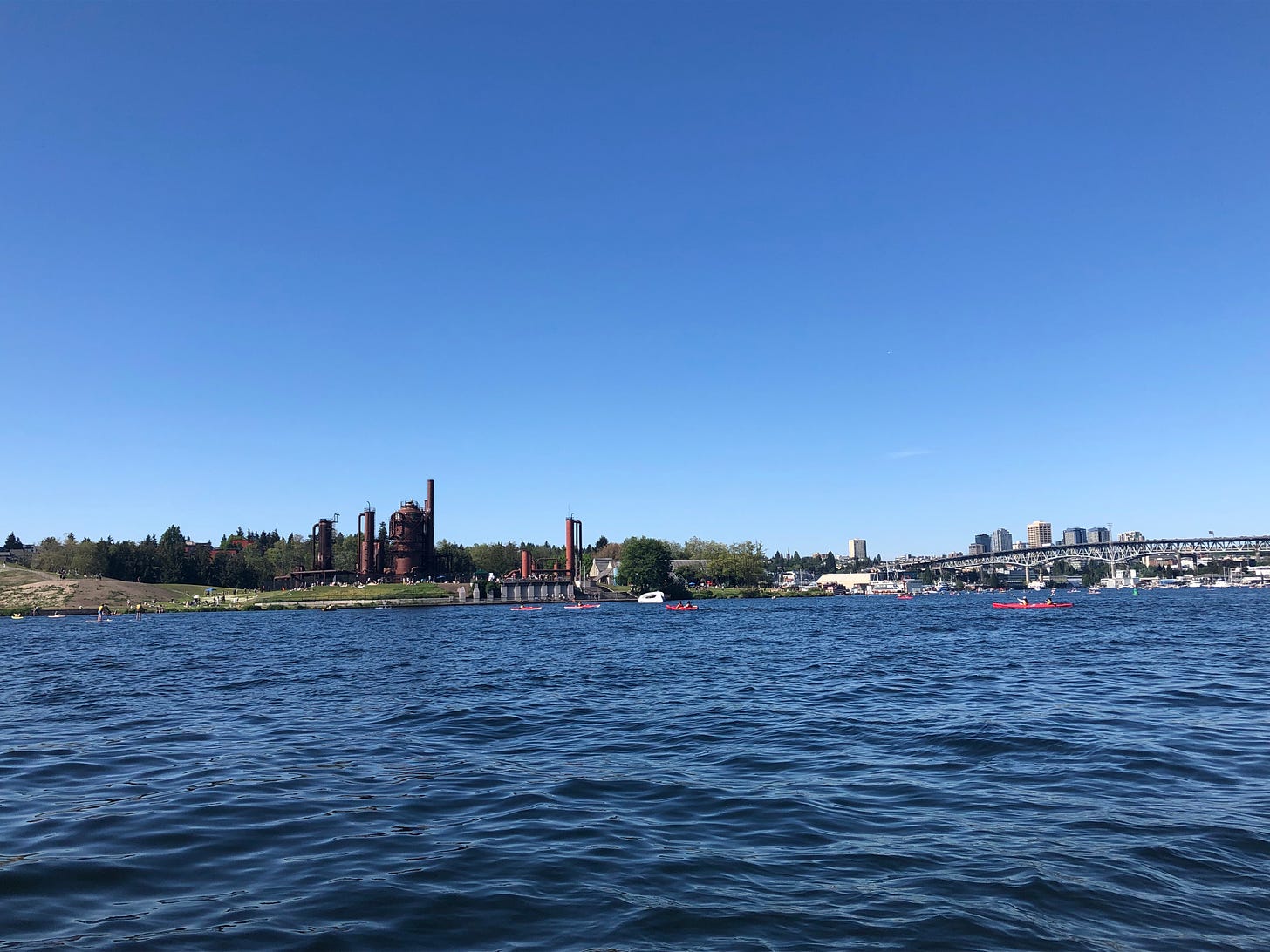 A photo looking out over the water in Seattle towards Gas Works Park. It's a sunny day.