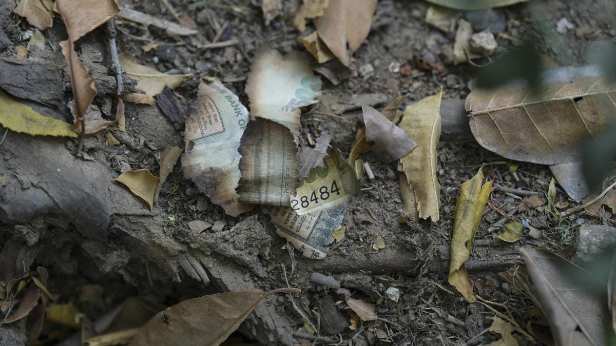 Burnt pieces of a currency notes seen among debris near the residence of Delhi High Court judge Justice Yashwant Varma in New Delhi on March 23, 2025.