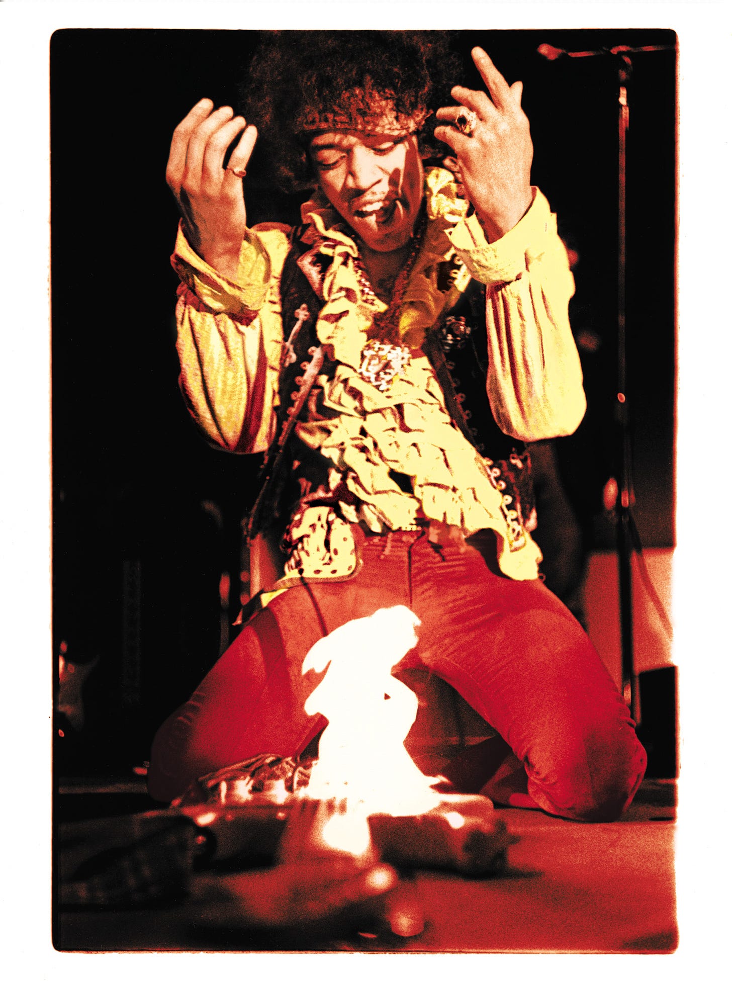 Photograph of Jimi Hendrix burning his guitar by Ed Caraeff.