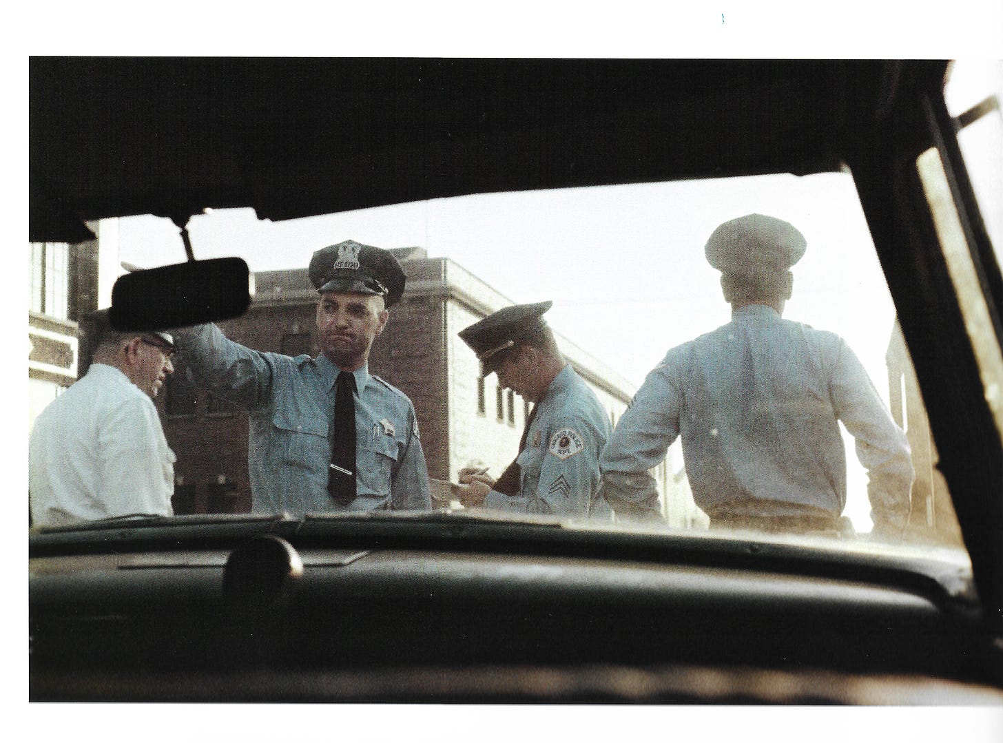 Four policemen, taken by Parks from the back seat of a police car