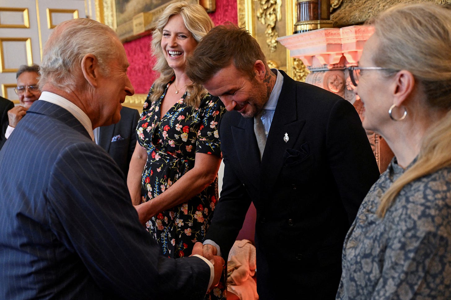 King Charles shaking David Beckhham's hand