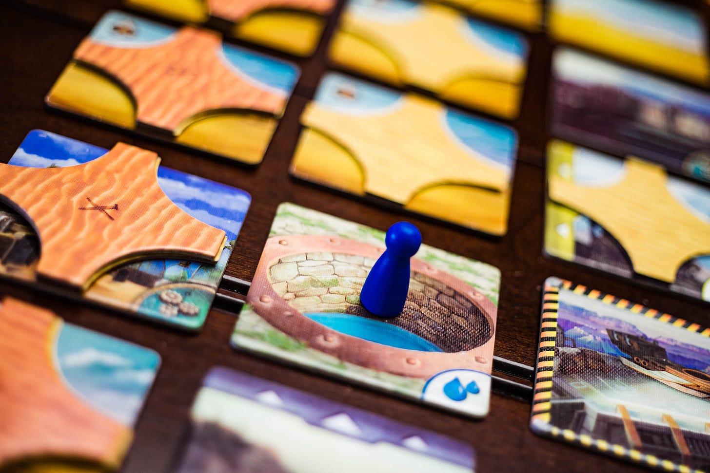 The board game Forbidden Desert, with a pawn on a water tile.